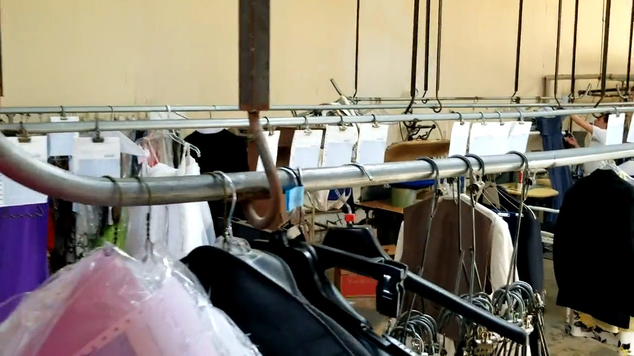 Cleaned garments in plastic moving along the rail at Clean Right Cleaners