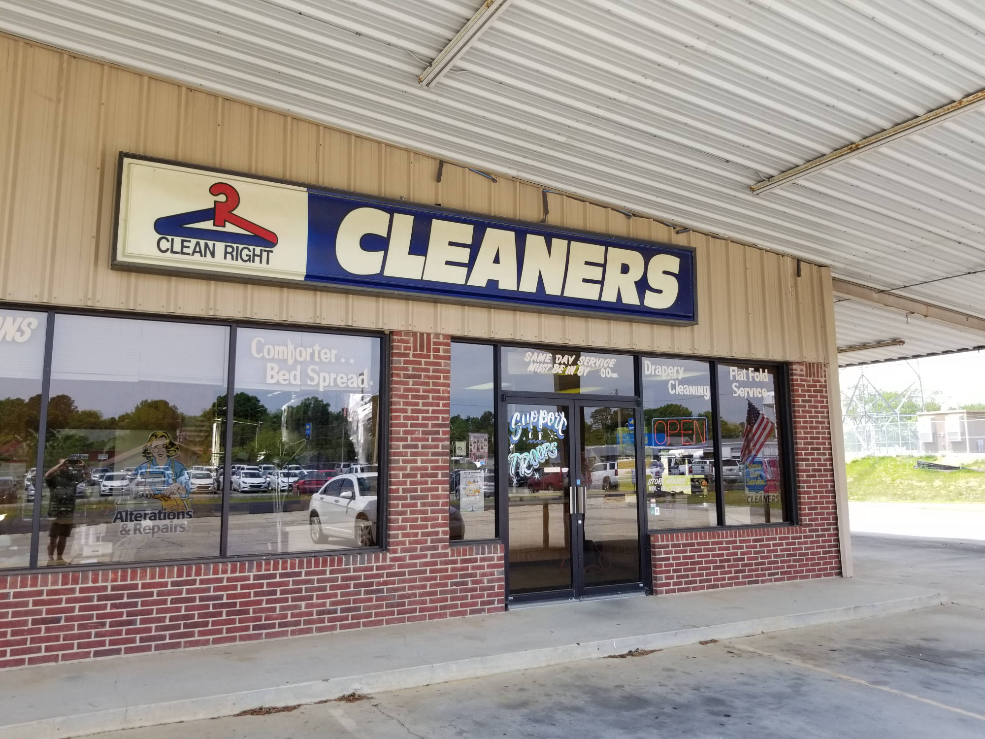 Store window lettering listing comforter, bed spread and drapery cleaning